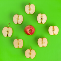 Fruit pattern of apple halves on green background. Flat lay, top view. Food background. .  Pop art design, creative summer concept.