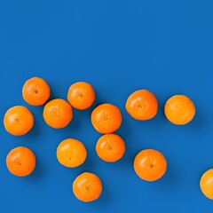 Fruit pattern of fresh orange tangerine or mandarin on blue background. Flat lay, top view. Pop art design, creative summer concept. Citrus in minimal style.