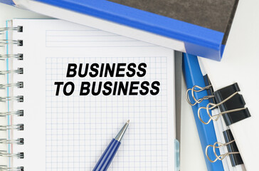Among the documents, folders, a notebook with the inscription - BUSINESS TO BUSINESS