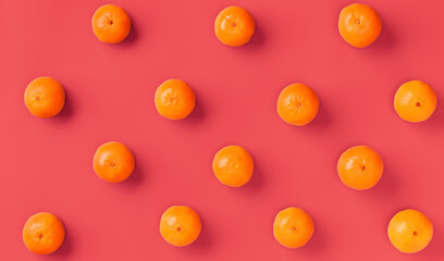 Fruit pattern of fresh orange tangerine or mandarin on living coral background. Flat lay, top view. Pop art design, creative summer concept. Citrus in minimal style.