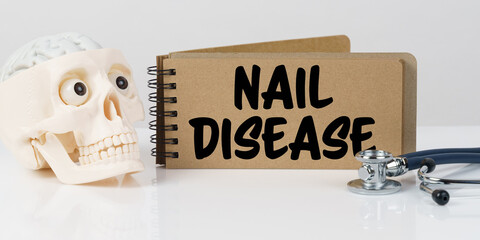 On the table lies a skull, a stethoscope and a notebook with the inscription - NAIL DISEASE