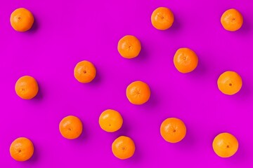 Fruit pattern of fresh orange tangerine or mandarin on lilac background. Flat lay, top view. Pop art design, creative summer concept. Citrus in minimal style.