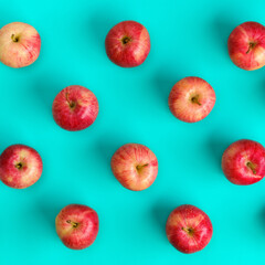 Fruit pattern of red apple on blue background. Flat lay, top view. Pop art design, creative summer concept. Food background.
