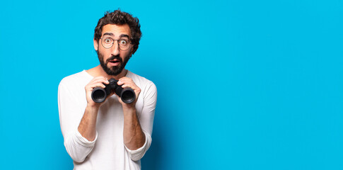 young crazy bearded man with binoculars