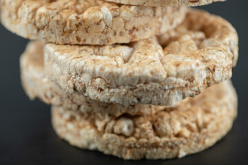 Pile of crispy rice cakes on black background