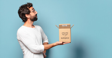 young crazy bearded man recibing a cardboard package