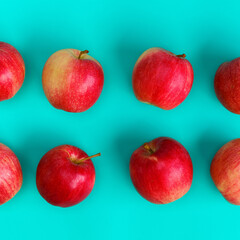 Fruit pattern of red apple on blue background. Flat lay, top view. Pop art design, creative summer concept. Food background.