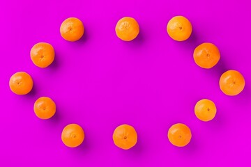 Fruit pattern of fresh orange tangerine or mandarin on lilac background. Flat lay, top view. Pop art design, creative summer concept. Citrus in minimal style.