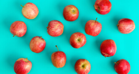 Fruit pattern of red apple on blue background. Flat lay, top view. Pop art design, creative summer concept. Food background.