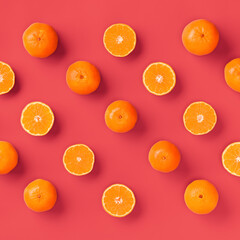 Fruit pattern of fresh orange tangerine or mandarin on living coral background. Flat lay, top view. Pop art design, creative summer concept. Citrus in minimal style.