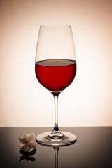 Glass with red wine on the sepia background
