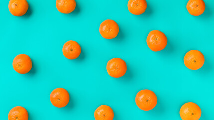 Fruit pattern of fresh mandarin on blue background. Flat lay, top view. Pop art design, creative summer concept. Citrus in minimal style.