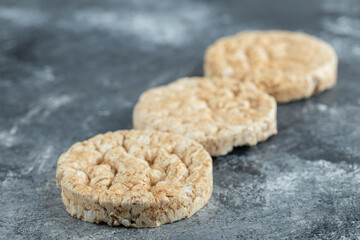 Three puffed rice cakes on marble background