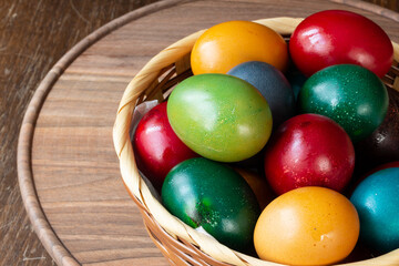Easter eggs and Easter bun with flowers - wood background