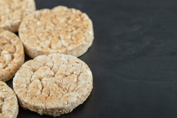 Crispy rice cakes on black wooden background