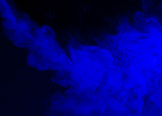 Abstract background of chaotically mixing puffs of blue smoke on a dark background