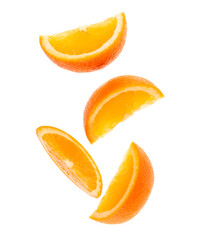 falling fresh orange fruit slices isolated on white background closeup. Flying food concept. Top view. Flat lay. Orange slice in air, without shadow.