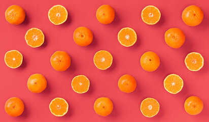 Fruit pattern of fresh orange tangerine or mandarin on living coral background. Flat lay, top view. Pop art design, creative summer concept. Citrus in minimal style.