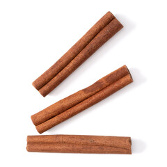 Cinnamon sticks isolated on white background closeup. Canella spice. Aromatic condiment background. Flat lay, top view.