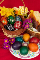 Easter eggs and Easter bun with flowers - red background