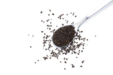 black tea granules isolated on white background. design element. indian beverage tea on spoon cut...
