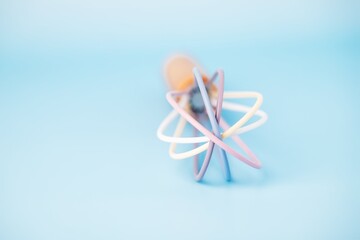 Colored plastic whisk for whipping on a blue background