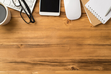 Top flat lay layout close up view photo image of copybooks cellphone eyewear mug of beverage on loft light brown background