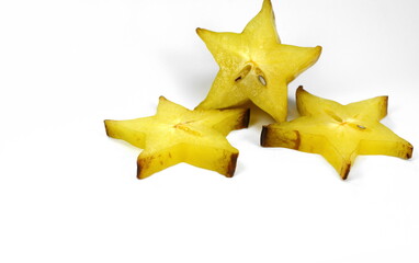 Star shaped slices of carambola fruit isolated on white background. Carambola fruit with slice of star fruit  isolated on a white background.