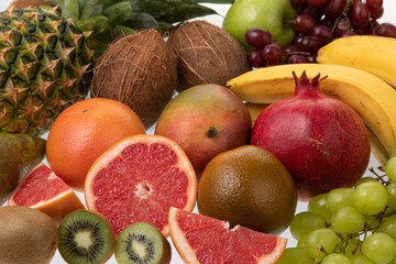 Naklejka na ściany i meble Background of fresh and sliced fruits from market on white background