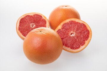 Sliced juicy grapefruits isolated on white