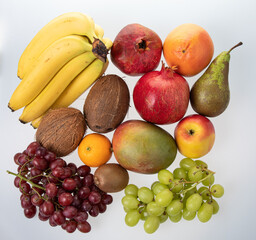Fresh exotic fruits on white background shot from top