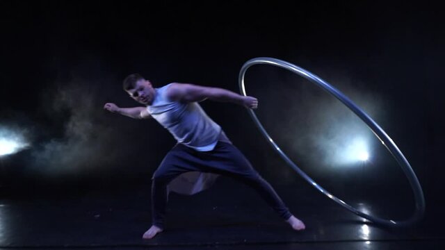 Circus artist dancing with cyr wheel. concept of concentration, willpower, and movement 