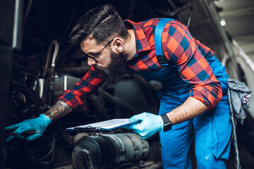 Professional bus mechanic working in vehicle repair service.