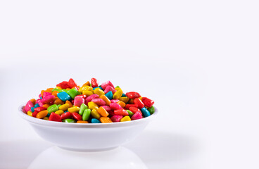 Mini colored chewing gums in the bowl - White background