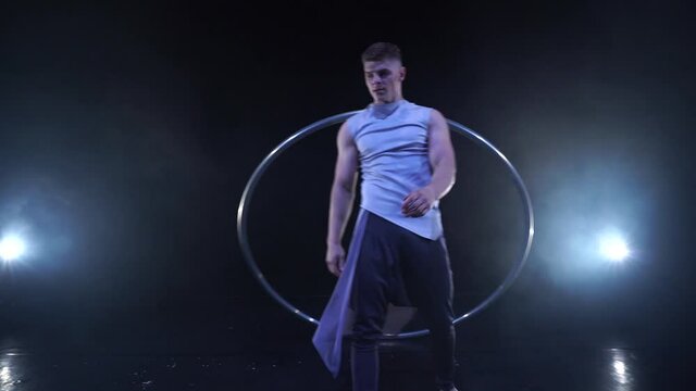 Circus artist dancing with cyr wheel. concept of concentration, willpower, and movement 
