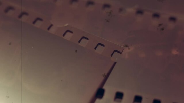 Old analog photography concept, detail of 35mm negative film with scratch and dust old movie effect