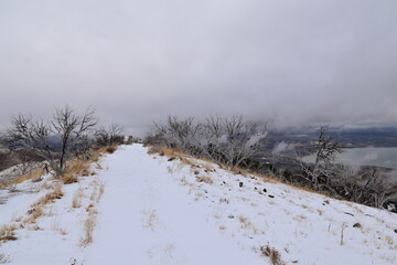 Snowy Hiking Trail views towards Lake Mountains Peak via Israel Canyon road towards Radio Towers in winter, Utah Lake, Wasatch Front Rocky Mountains, Provo, United States.