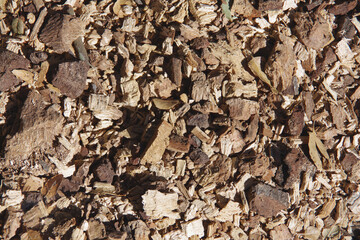 High angle full frame close-up view from directly above of an area of rough wood chips