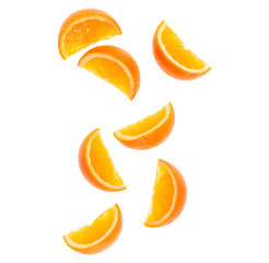 falling fresh orange fruit slices isolated over white background closeup. Flying food concept. Top view. Flat lay. Orange slice in air, without shadow..