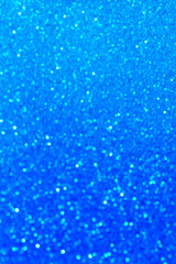 Abstract blue glitter lights background. Circle blurred bokeh. Festive backdrop for Christmas, holiday or event. Winter Card or invitation