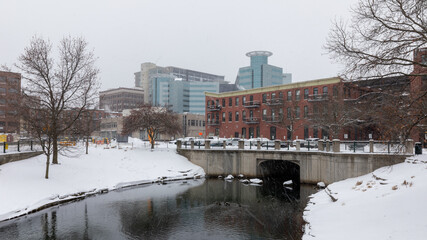 Fototapeta na wymiar Kalamazoo, Michigan, USA - February 5 2021: Downtown Kalamazoo in snow. view from Arcadia Creek playground.