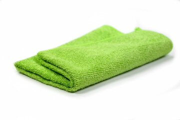 Green micro fiber towel isolated on white background. Clean, new green microfiber cloth isolated on white background