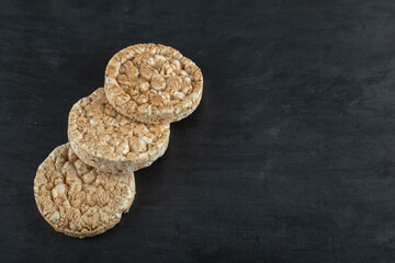 Pile of crispy rice cakes on black background