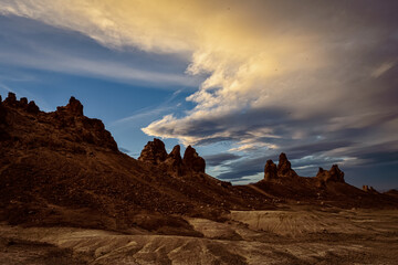 Cloudy sky above Trona Pinnacles natural rock formations in California desert landscape