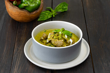 Beef soup served in a ceramic bowl.