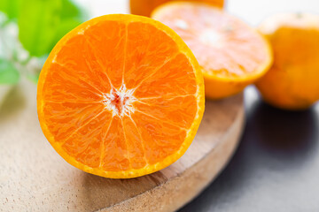 Fresh orange fruit sliced on cutting board with leave and citrus blured.  tropical fruit orange...