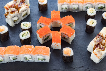 Assorted from the roll. Japanese cuisine. rolls on a stone platter. serving the table.