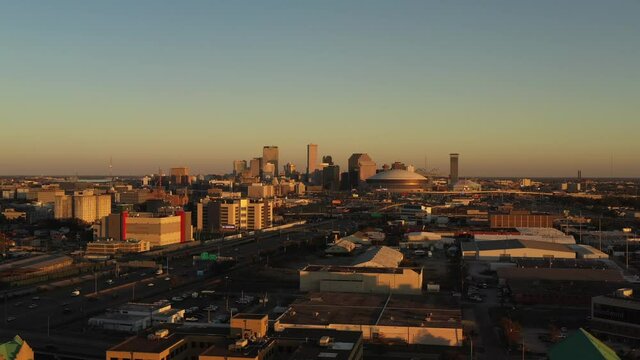 New Orleans City Skyline Wide City Traffic with Superdome Drone Slow Rise Up Shot at Sunset - Mavic 2 Pro - Urban Landscape - Louisiana