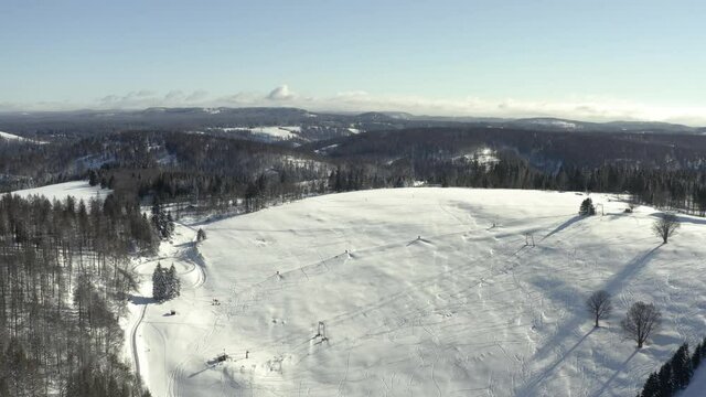 Aerial footage of the harz after a heavy snow storm in the winter of 2021. The Harz is a german national Park in with beautiful mountain landscapes in central Germany, Europe.