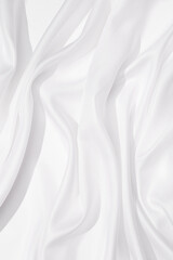 Naklejka na ściany i meble Cloth texture background white colors. Bright satin fabric with creases on fabric close up.